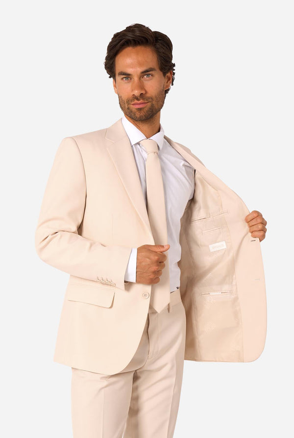 Man wearing a sand colored suit on a white background