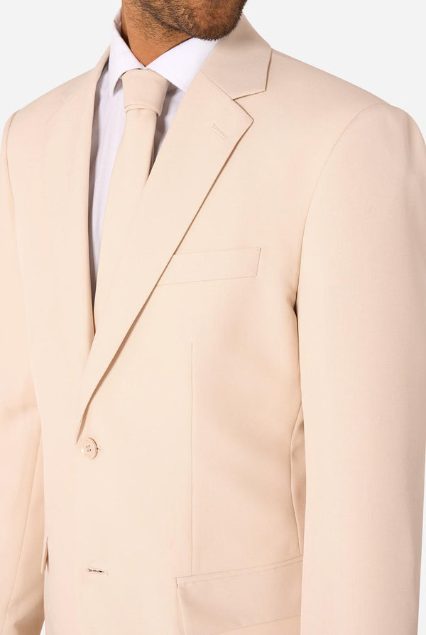 Sand colored suit jacket worn by a person on a white background
