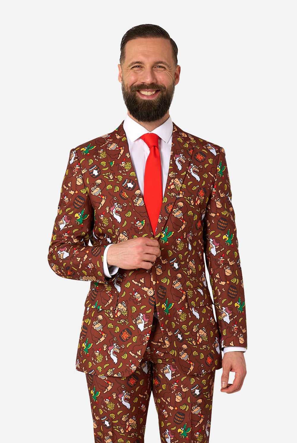 Man wearing a Donkey Kong patterned suit with a red tie on a white background