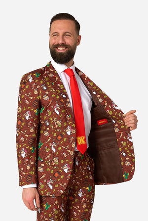 Man wearing a Donkey Kong patterned brown suit with a red tie on a white background
