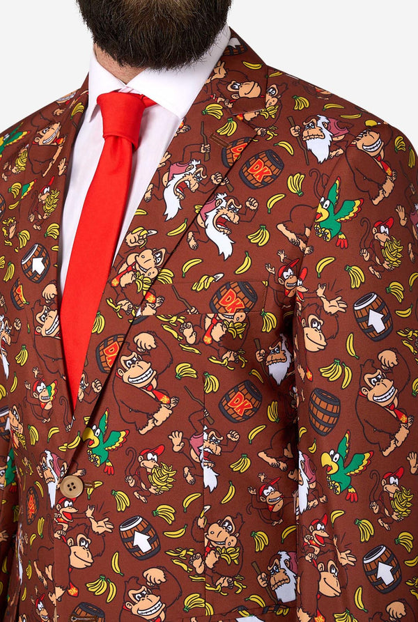 Man wearing a patterned suit with Donkey Kong characters and a red tie.