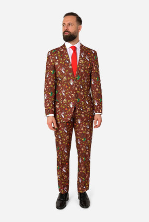 Man wearing a brown Donkey Kong patterned suit with a red tie on a white background. Full body image.