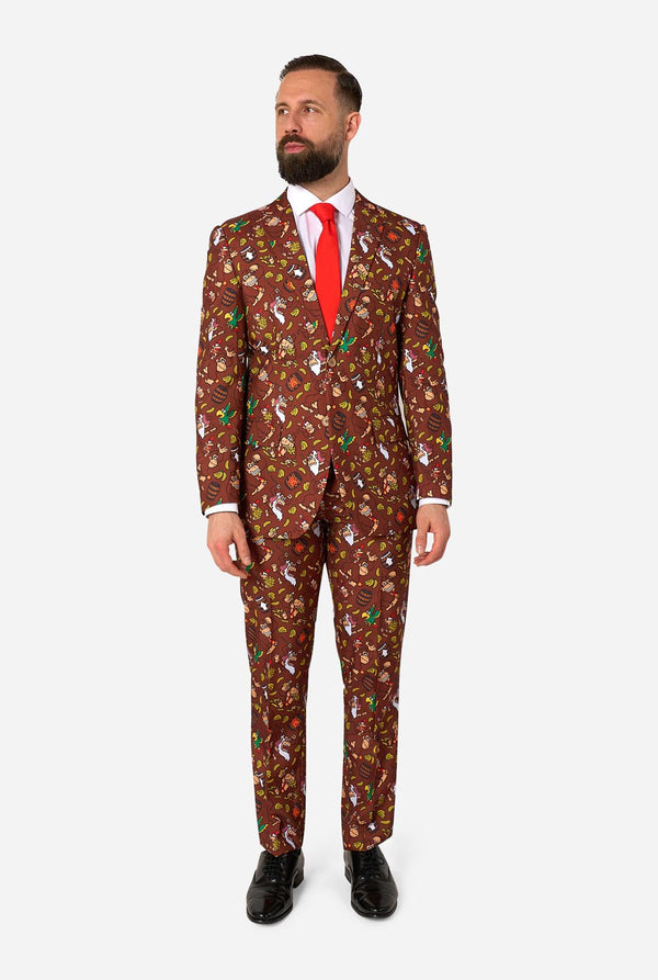 Man wearing a brown Donkey Kong patterned suit with a red tie on a white background. Full body image.