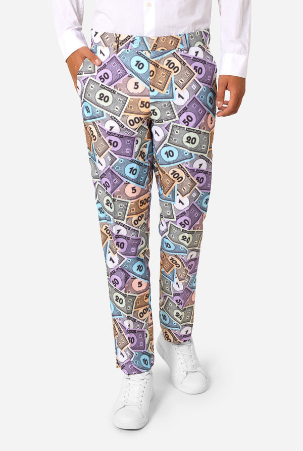 Person wearing colorful dollar bill patterned pants on a white background