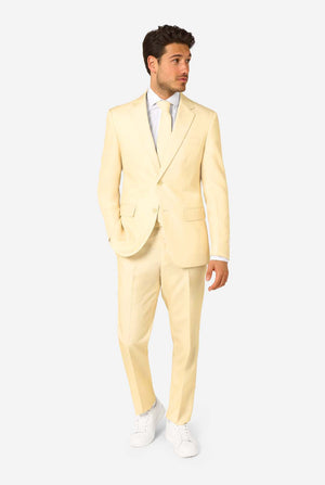 Man wearing a light yellow suit with a white shirt on a white background. Full body image