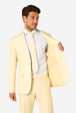 Man wearing a light yellow suit with a white shirt and tie on a plain background