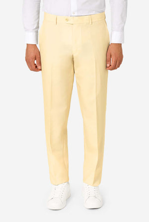 Yellow pants worn with a white shirt and shoes on a light gray background