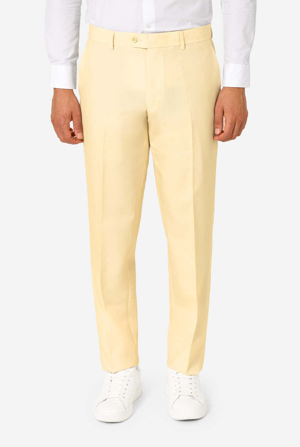 Yellow pants worn with a white shirt and shoes on a light gray background