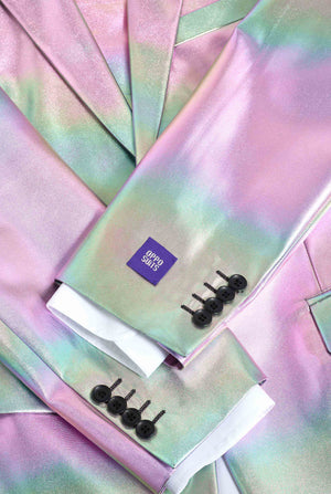 Iridescent fabric with a small purple label and black hair clips on a matching background.