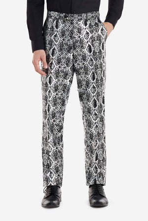 A man is wearing an eye-catching silver and black snake-print suit by OppoSuits. The striking suit features a bold snakeskin pattern, offering a sleek, fashionable look perfect for parties, events, or making a daring fashion statement. The men suit is paired with a black dress shirt and a matching snake-print tie, adding a sophisticated edge to the overall ensemble. Close up of the pants.