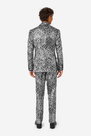 Person wearing a black and silver star patterned suit on a white background