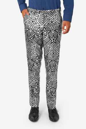 Person wearing black and silver geometric patterned pants on a white background