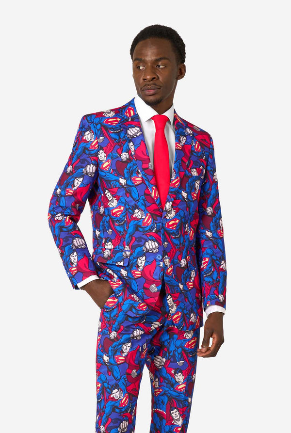 Man wearing a colorful superhero-themed suit with a red tie on a white background