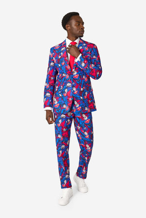 Man wearing a colorful superhero-themed suit with a pattern on a white background