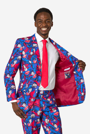 Man wearing a colorful superhero-themed suit with a red tie on a white background