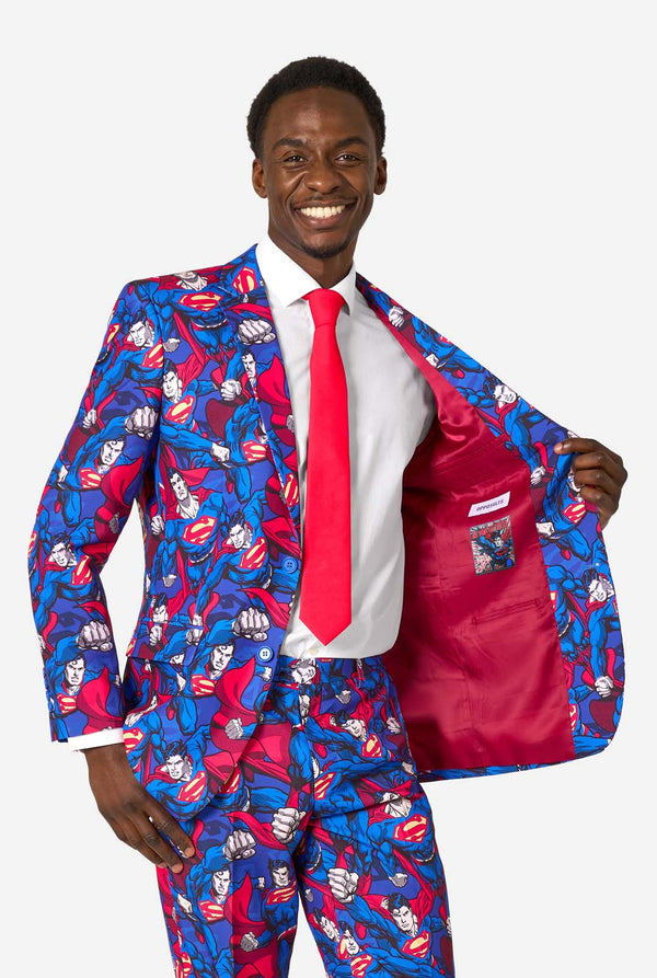 Man wearing a colorful superhero-themed suit with a red tie on a white background