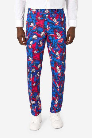 Superman patterned pants worn by a person on a white background