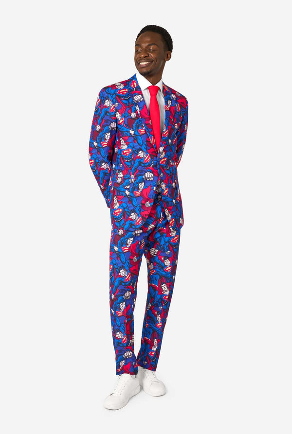 Man wearing a Superman-themed colorful suit with a pattern on a white background