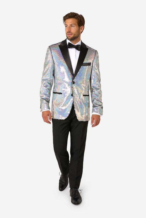 Man wearing a holographic sequin tuxedo jacket on a white background