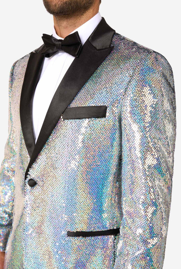 Man wearing a sparkling holographic tuxedo with black lapels and bow tie on a white background