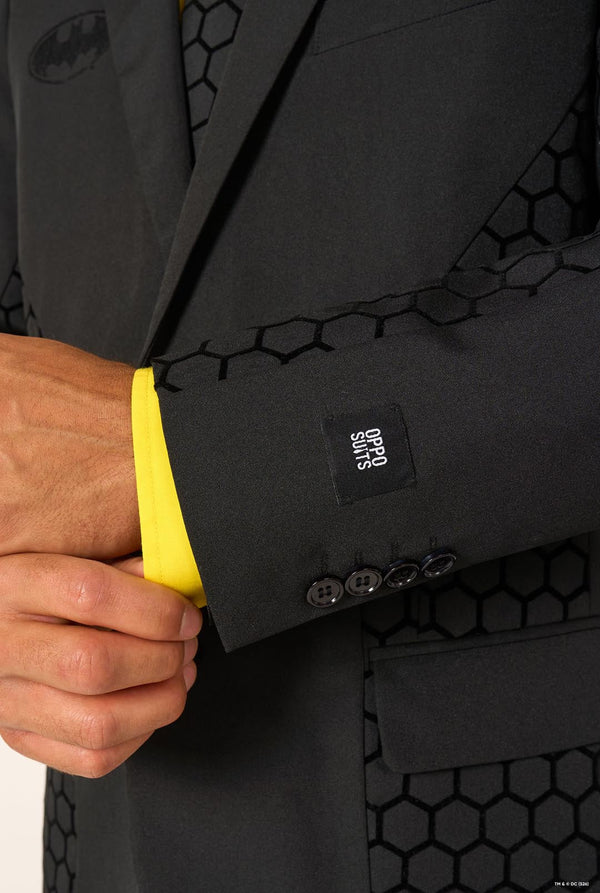 Black suit jacket with yellow shirt collar and hexagonal pattern, featuring a Batman logo.
