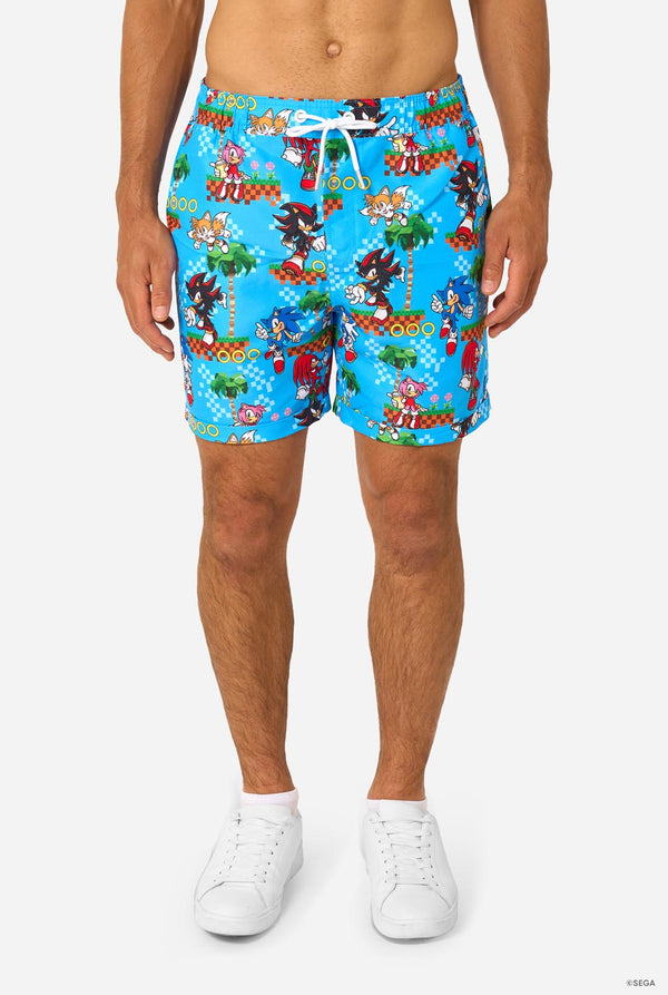Person wearing colorful Sonic-themed shorts on a white background