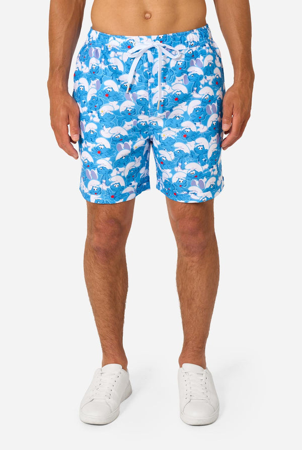 Person wearing blue shorts with Smurf pattern on a white background