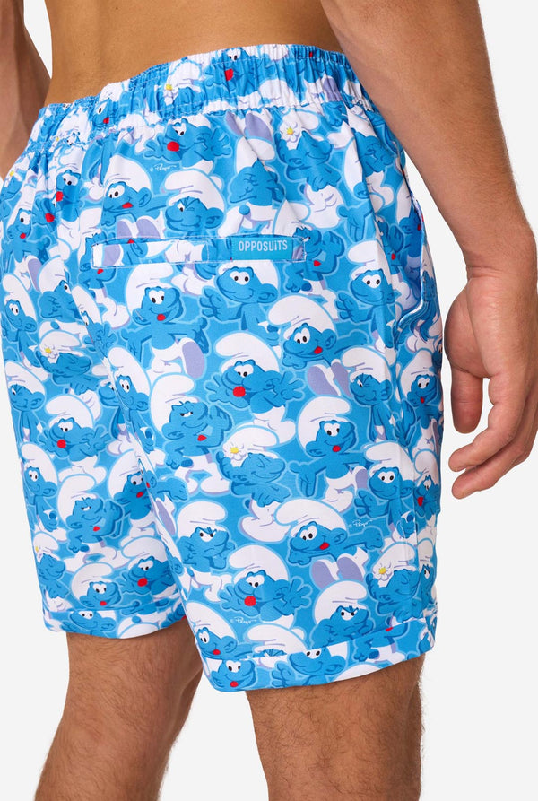 Blue shorts with Smurf character pattern on a white background