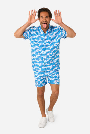 Man wearing a blue and white Smurf patterned shirt and shorts on a white background. Full body image.