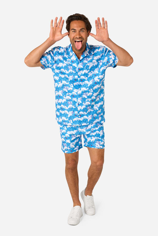 Man wearing a blue and white Smurf patterned shirt and shorts on a white background. Full body image.