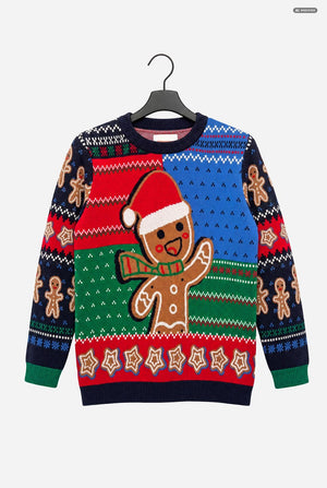 A festive Christmas crewneck sweater featuring a large gingerbread man wearing a Santa hat on the front, with traditional Nordic patterns in red, blue, green, and navy on the sleeves and body, hanging on a black hanger against a light gray background.
