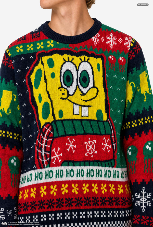 A close-up of a person wearing a festive holiday sweater featuring SpongeBob SquarePants. The sweater is multicolor with a large yellow SpongeBob graphic in the center, green and red patterns, and 'HO HO HO' text along the bottom.