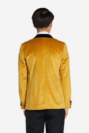 Teen wearing golden velvet dinner jacket, view from the back