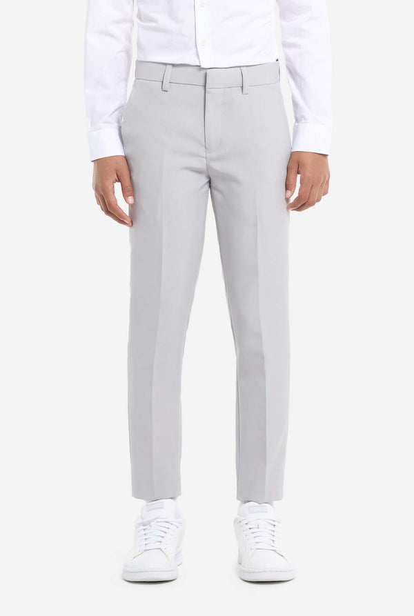 In this image, a kid is wearing a formal grey suit. The suit consists of a blazer, pants and tie. Pants view