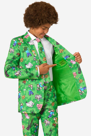 Child wearing a green suit with Minecraft character patterns on a white background