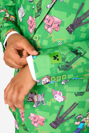 Green shirt with Minecraft character pattern, hand adjusting collar