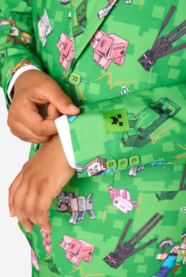 Green shirt with Minecraft character pattern, hand adjusting collar