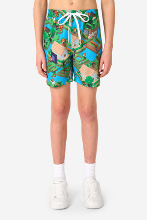 Person wearing colorful shorts with a Minecraft-themed design on a white background