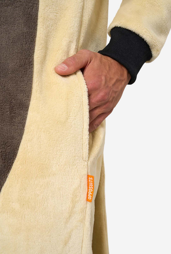 Close-up of a person holding a fleece onesie with a visible brand tag on a white background