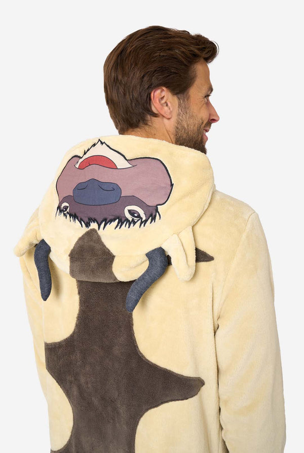 Person wearing a cream-colored onesie with an Avatar character on the back against a white background