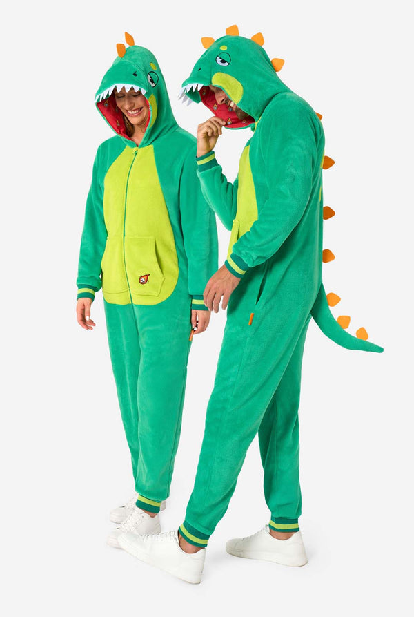 Two people wearing green dinosaur onesies on a white background. Full body image