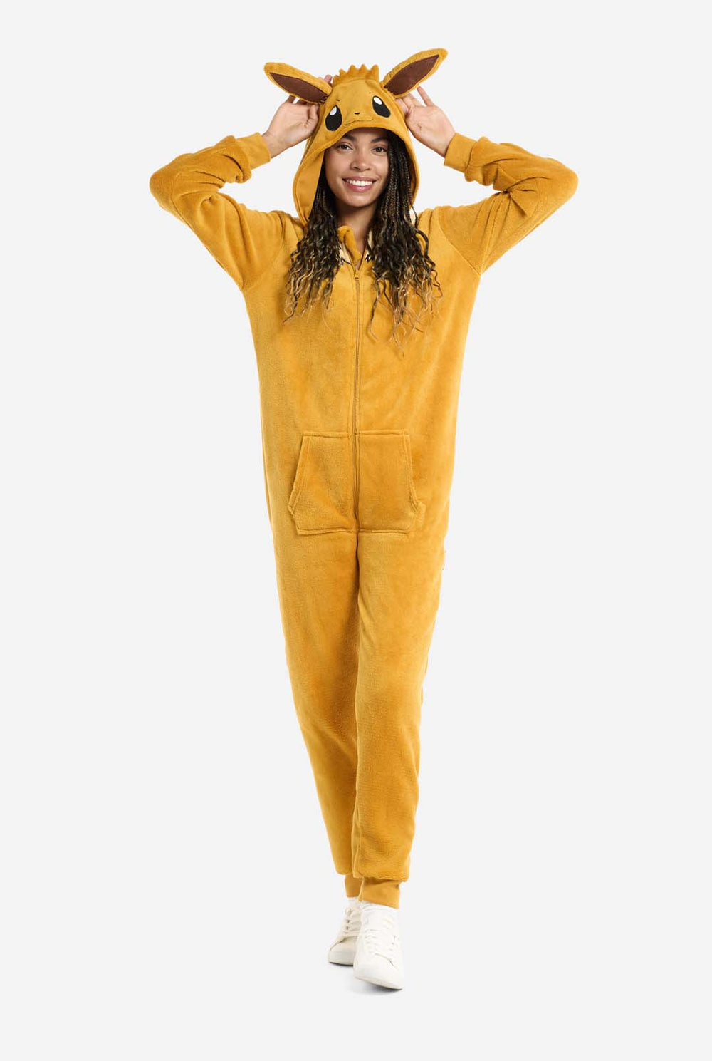 A man is wearing an adorable Eevee onesie, modeled after the beloved Pokémon character. This adult unisex onesie is designed in a warm brown color, resembling Eevee’s fur, and features a fluffy beige collar mimicking Eevee’s mane. The hood includes Eevee's signature large brown ears, big black eyes. The onesie has a front zipper closure and convenient pockets at the front, offering both comfort and ease of wear. Perfect for Pokémon fans.