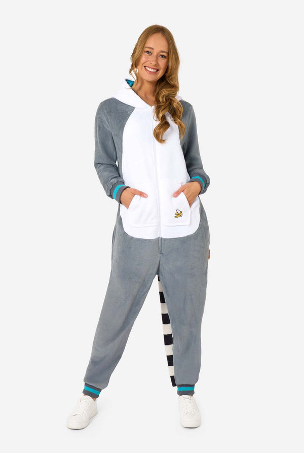 Woman wearing a gray and white lemur onesie with colorful accents on a white background. Full body image