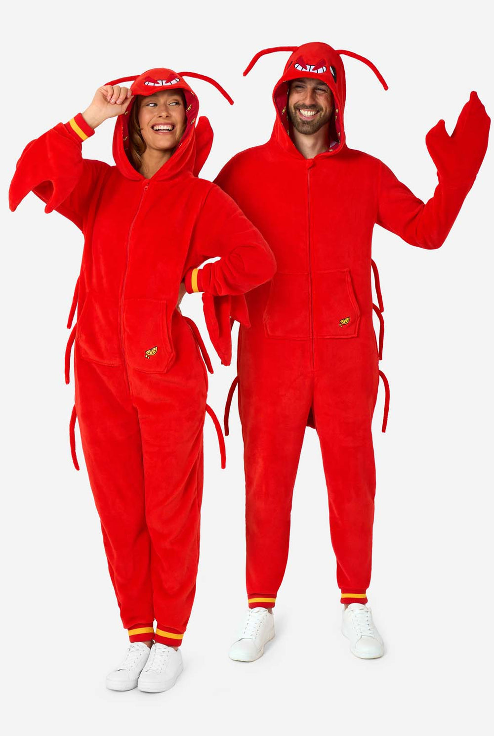 Two people wearing red lobster-themed onesies against a white background