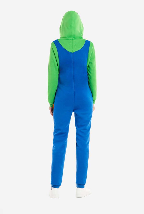A woman is dressed in a Luigi-themed onesie. The outfit features a bright green hoodie with an "L" symbol on the hood and blue overalls with large yellow buttons on the straps. View from the back. The overall design mimics the look of the popular video game character Luigi, with contrasting green and blue colors. The background is plain, putting focus on the costume and the woman's playful pose.