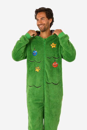 Person wearing a green onesie with decorative elements on a white background