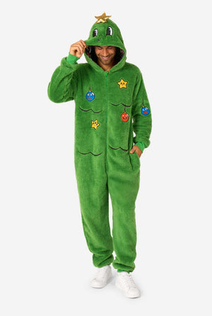 Person wearing a green onesie with cartoon character patches on a white background