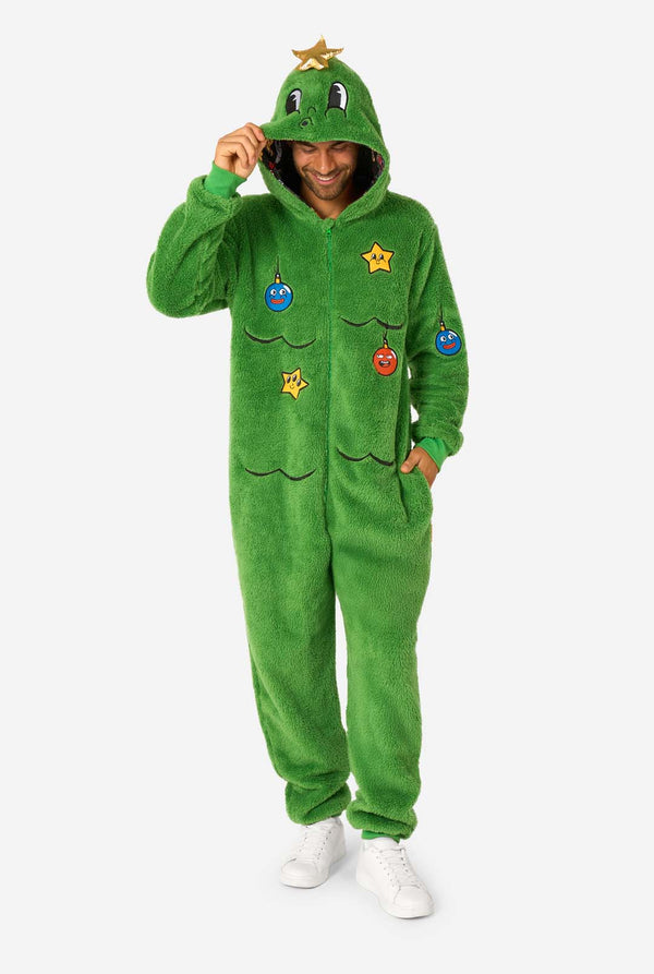 Person wearing a green onesie with cartoon character patches on a white background