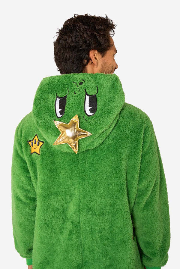 Person wearing a green character onesie with star and eye designs on a white background