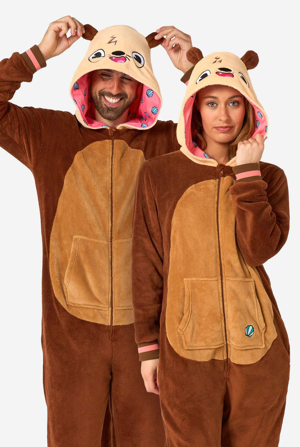 Two people wearing brown otter-themed onesies on a white background